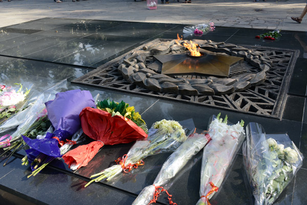 Fresh flowers laid at the eternal flame, Panfilov Park