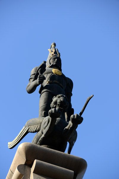 Statue of the Golden Man atop a winged snow leopard