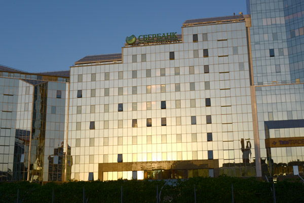Afternoon sun shining on the glass of the modern Nurlytau Complex, Almaty