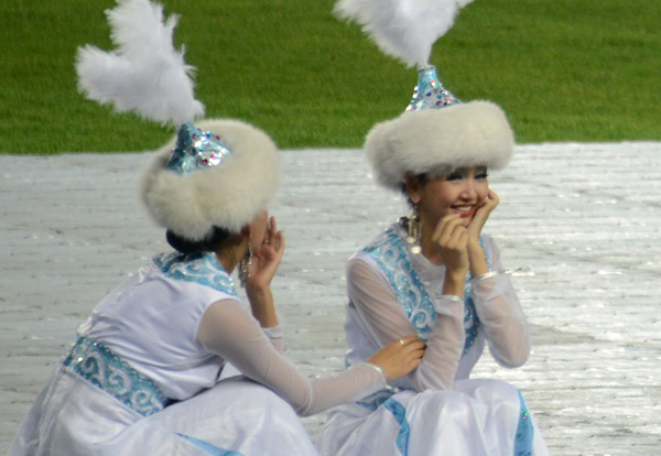 Kazakh dancers resting on the side during the ceremony