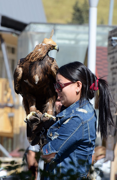 Tourists pay to pose with the eagle