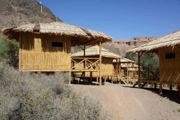 Huts of the simple lodge along the Sharyn River