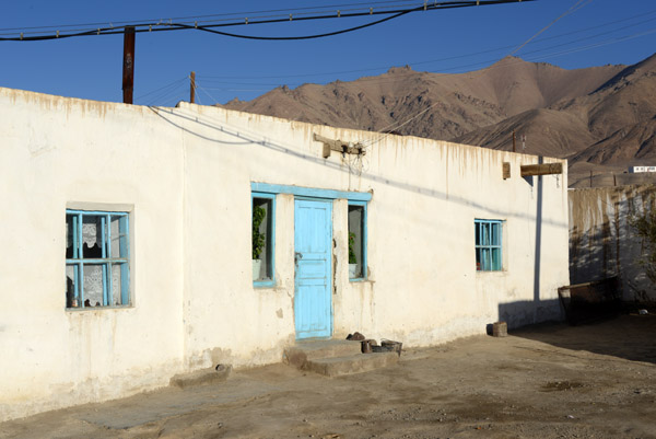 Typical Murghab house, whitewashed with a blue door