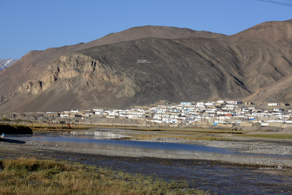 The town of Murghab with Welcome our Hazirimam spelled out high on the mountainside
