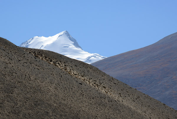 A snow capped peak in the center of the Wakhan Corridor, perhaps 18,000 feet tall