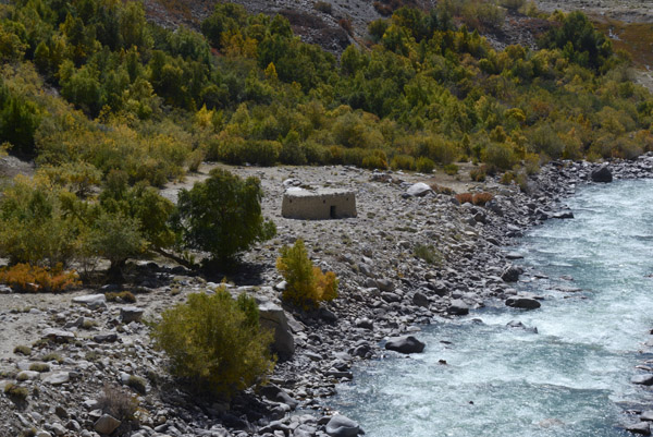 A small mudbrick hut in a clearing surrounded by trees, Wakhan Corridor, Afghanistan