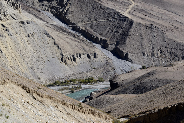 A dry riverbed and the caravan trail on the Afghan side of the Pamir River