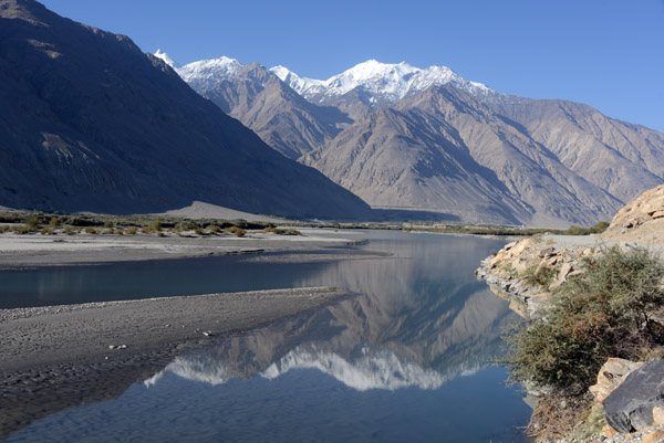 The Afghan mountains reflected in the Panj River, Wakhan Valley