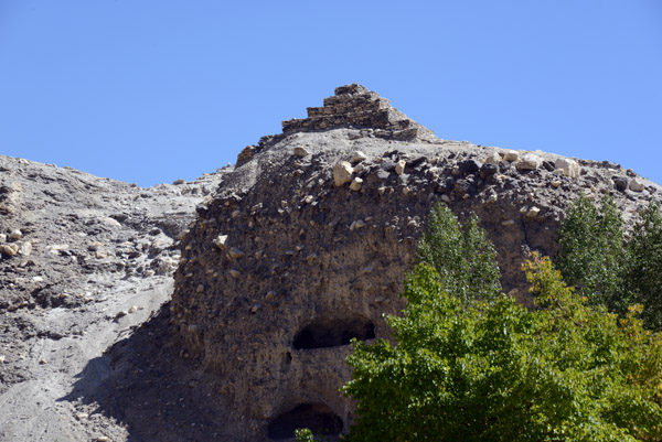 Large caves have been cut into the hillside beneath the stupa at Vrang