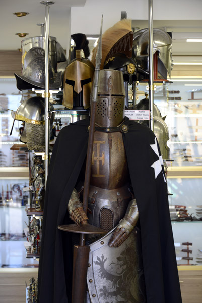Suit of armor with a black cloak and cross