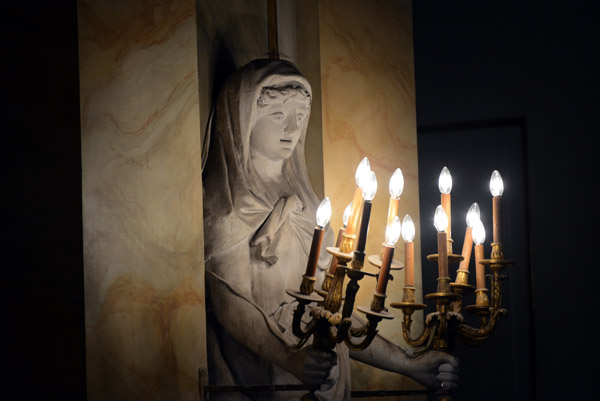 Sculpture of a woman holding a candelabra in the Old Orangery Theater