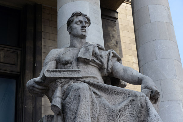 Socialist Realism sculpture of a seated road worker holding a ledger and a jackhammer, PKiN