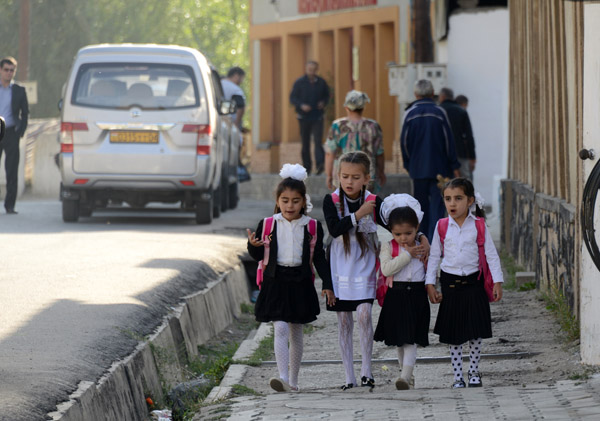 School girls in Tajikistan still wear the black and white maid's uniform dating from the Soviet times