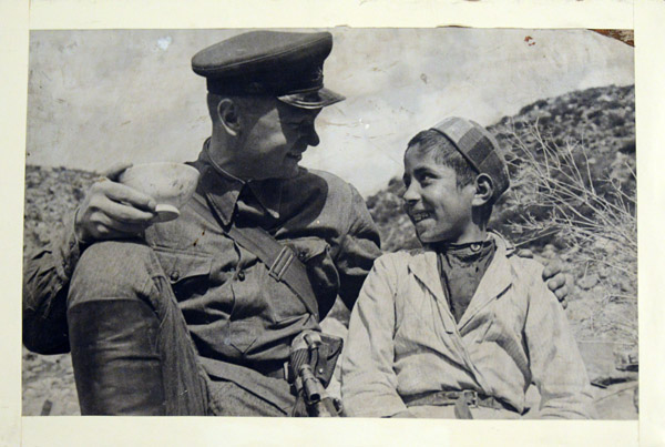 Vintage photo of a Soviet soldier and a local boy