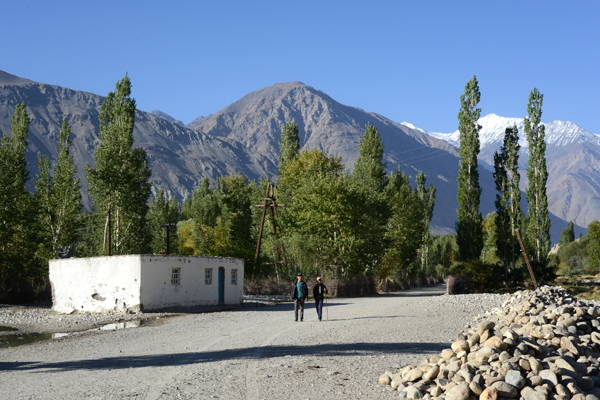 Two guys walking the deserted main street of Langar, Wakhan Valley, Tajikistan