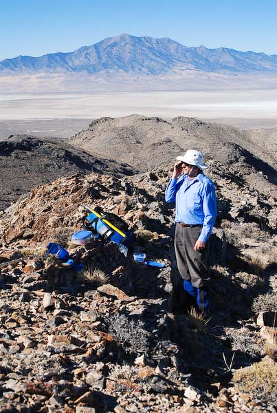 Phoning home from Tetzlaff Peaks summit ridge
