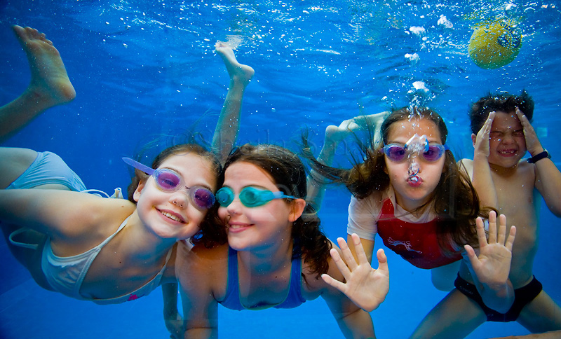 Four children swimming underwater