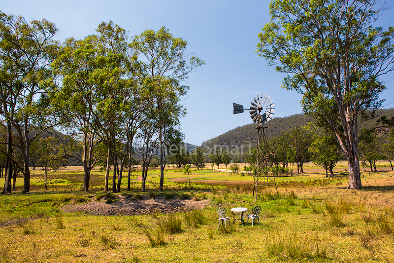 Australian paddock with wind mill for drawing water