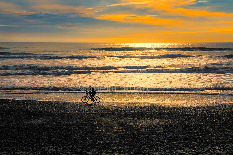 Cyclist on beach 