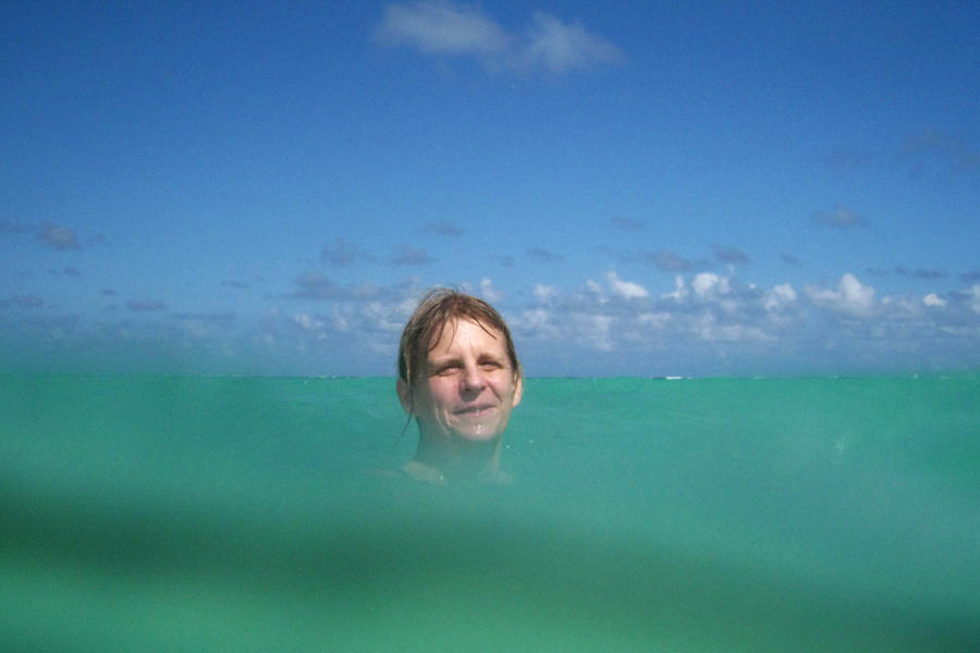 Julie behind a wave