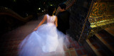 A wedding couple making their way down the steps