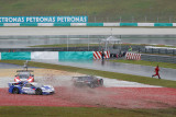 SEPANG, MALAYSIA - JUNE 21: Three race cars crash out into the gravel trap of turn 15 in the rain during the Autobacs (Japan) Su