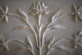 carved floral designs on white marble