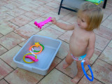 Kristina throws toys in the water