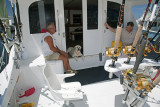 Capt. Buddy Hooper Relaxing With His Dog and A Friend