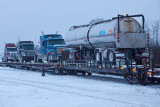 Tanker and trucks on flatcars