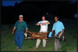 Rolando (left), Jorge and Alex carry the beast to our dinner table