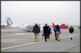Boarding the chartered plane in drizzling rain
