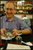 With the help of an electronic dictionary, Alan attempts to decipher the cow fur-covered menu.