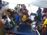 bikes & riders loaded onto boat at Tanjung Leman