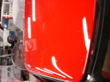 You can read BMW in the reflection of the flag