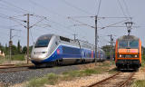 A TGV Duplex is overtaking the BB26200 with a freight train at Les Arcs-Draguignan.