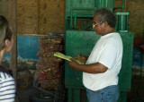 Benito checking a recycling list. One of two compactor in background. L1009869.jpg
