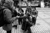 Begging in the street and training his children.
