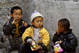 Three boys eating chips Dali China