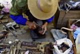 Shoemaker repairing heel. Dali, China.
