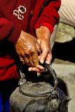 Woman holding a teapot. Dali, China.