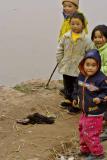 Children playing with a dying duck in Birdflu territory.  Ping shan Po winter 2005-2006