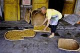 Taking corn mash after it has been used for wine to dry for feed.