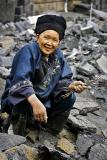 Miao elder collecting scrap metal.