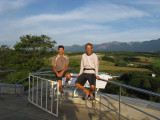 Volcanic mountains in the background are still releasing steam.