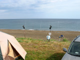 Locals fishing from shore. Use of multiple poles is common.