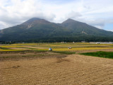 We descend into a large valley surrounded by rice fields.