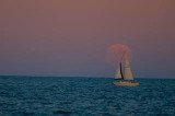 Sailboat in front of full moon