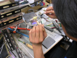 Each flower is then made to 'bloom' by slowly pressing the milli chip into the base glass and spreading it during the process.