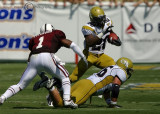 Jackets A-back Jones uses a prone teammate to avoid MSU DB Fitzhugh